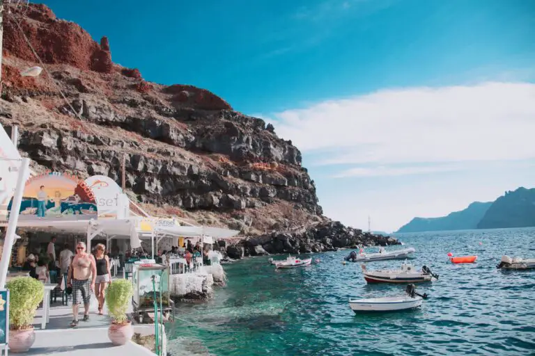 An image of sea with people and boats in Santorini, Greece